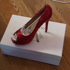 Valiant’s Celine Red Glitter Heels.